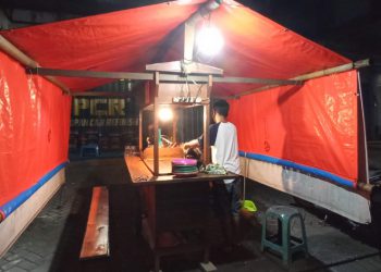 Anton saat menutup angkringannya pada masa PPKM di Kota Malang. (Foto: J Krisna/Javasatu.com)