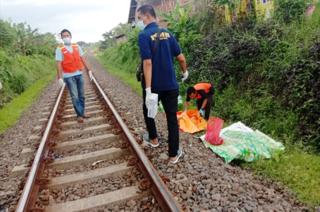 Petugas Polsek Singosari mengevakuasi jenazah korban kecelakaan KA Penataran di lintasan Desa Tunjungtirto Singosari Malang. (Foto: Istimewa)