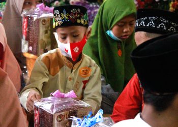 Ekspresi kegembiraan yang ditunjukkan seorang anak penerima santunan. (Foto: J Krisna/Javasatu.com)